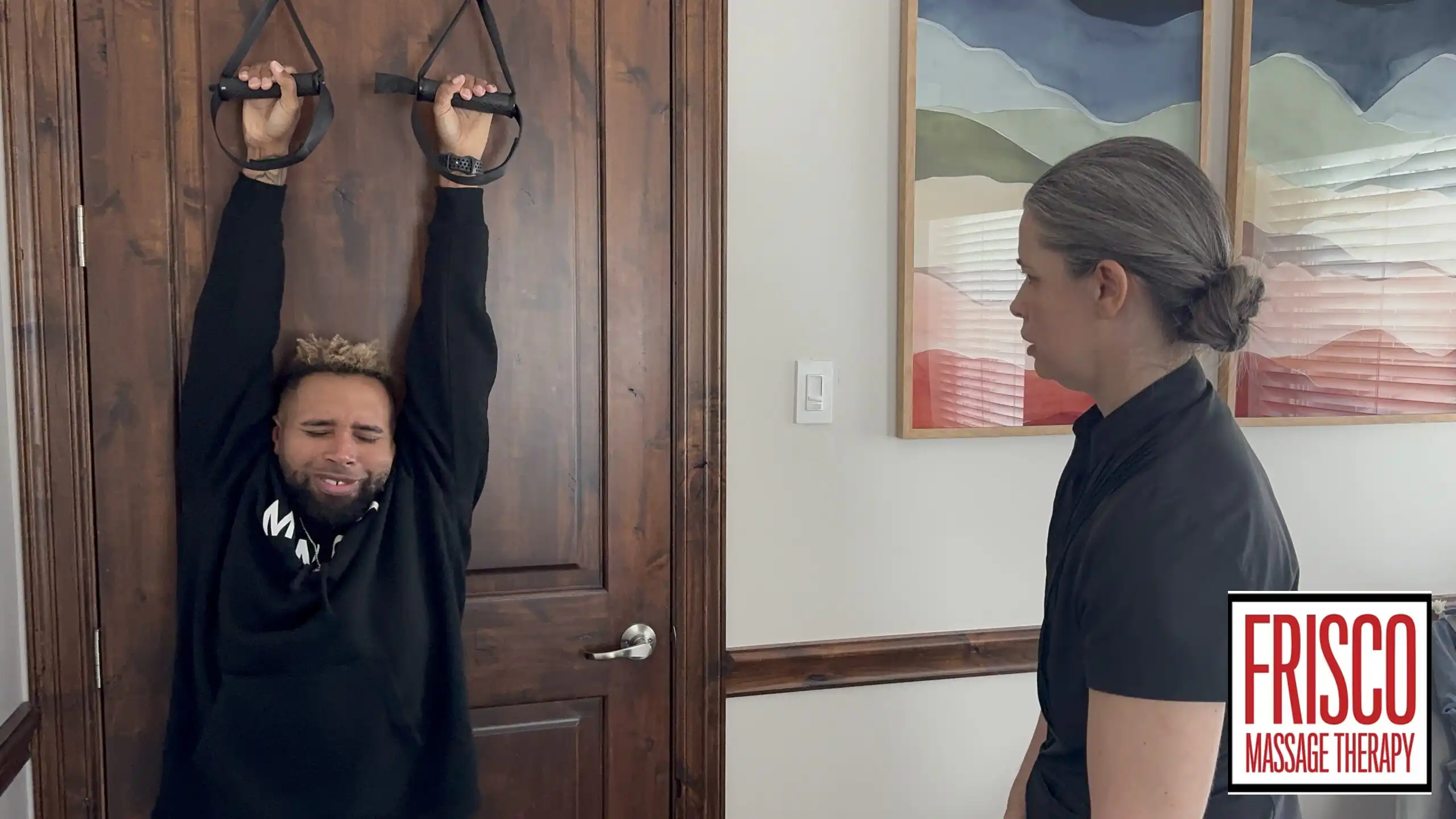 A person hangs from door-mounted straps while another person observes, suggesting techniques like cupping. The Frisco Massage Therapy logo is displayed in the lower right corner.