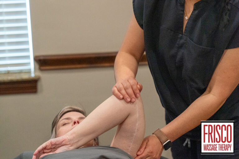 A massage therapist gently stretches a client's arm while the client lies on a table, offering relief for issues like C-Section scar pain; "Frisco Massage Therapy" logo appears in the corner.
