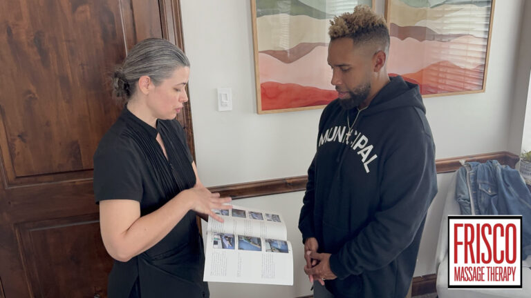 A woman shows a man a booklet while discussing its contents, highlighting the benefits of therapeutic massage for an active lifestyle. The Frisco Massage Therapy logo is visible in the lower right corner.