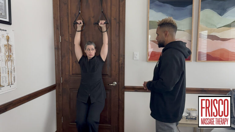 A woman hangs from fitness rings attached to a door while a man stands nearby observing, emphasizing the importance of athlete care. A Frisco Massage Therapy sign is visible in the lower right corner.