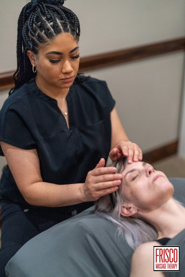 A massage therapist gives a head massage to a client lying on a table, focusing on techniques that can help with chronic pain. The Frisco Massage Therapy logo is visible in the bottom right corner.