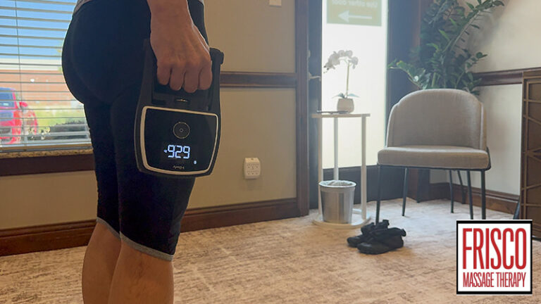 A person holds a handheld massage device in a clinic room with a chair, small table, and the Frisco Massage Therapy logo in the corner, highlighting an environment where clients can relax and track body composition while on GLP-1 medication.